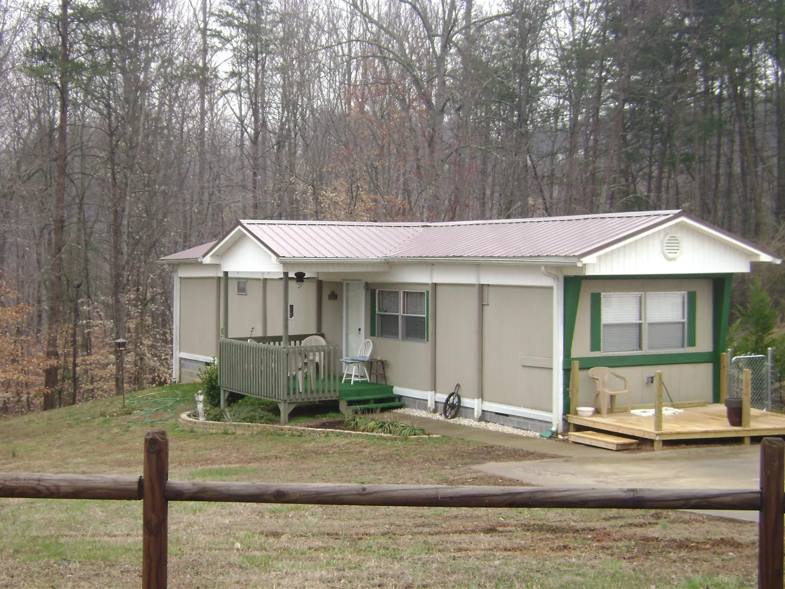 Mauve metal roof on a manufactured home with a new front deck in Merrick